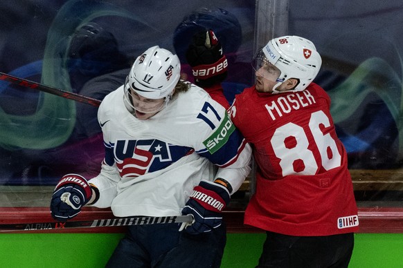 Switzerland&#039;s Janis Moser, right, in action against United States&#039; Adam Gaudette during the Ice Hockey World Championship quarter final match between Switzerland and the United States of Ame ...