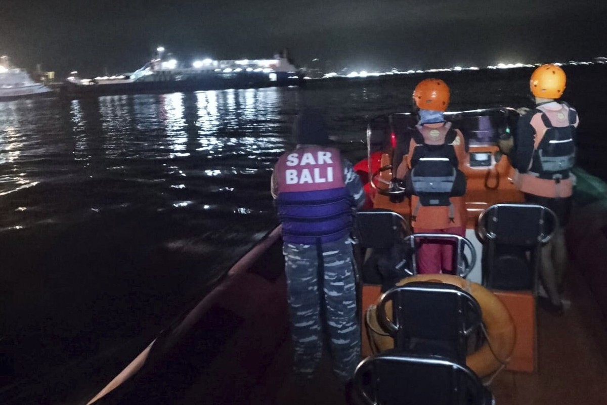 In this photo released by the Indonesian National Search and Rescue Agency (BASARNAS) rescuers search for victims after a ferry enroute for the resort island of Bali sank off Ketapang, East Java, Indo ...