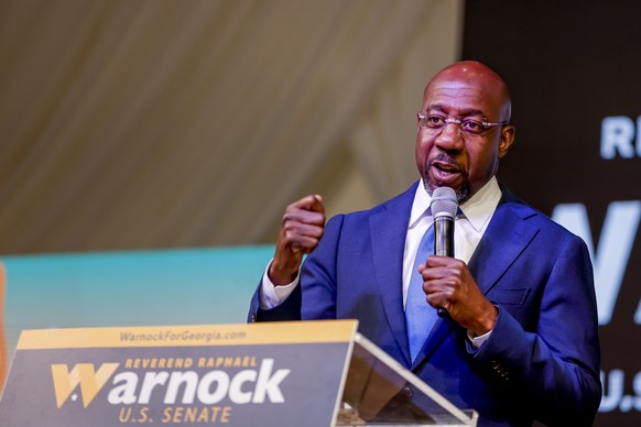 epa10209881 Democratic US Senator from Georgia Raphael Warnock meets with Korean American seniors during a campaign event in Norcross, Georgia, USA, 27 September 2022. Warnock is running against Repub ...