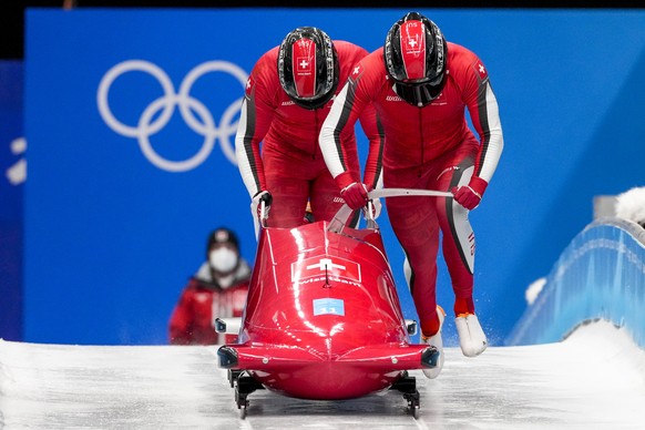 Michael Vogt and Sandro Michel, of Switzerland, start the 2-man heat 3 at the 2022 Winter Olympics, Tuesday, Feb. 15, 2022, in the Yanqing district of Beijing. (AP Photo/Dmitri Lovetsky)