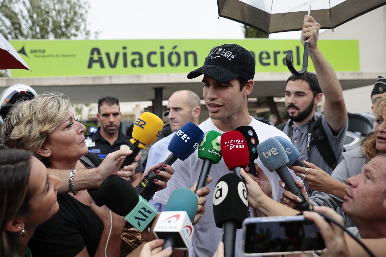 epa10181011 Spanish tennis player Carlos Alcaraz speaks to journalists after landing at Manises airport, in Valencia, Spain, 13 September. Alcaraz won Us Open tennis on 11 September. Alcaraz, new worl ...