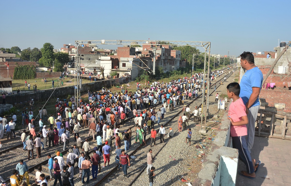 A crowd gathers at the site of Friday's train accident in Amritsar, India, Saturday, Oct. 20, 2018. A speeding train ran over a crowd watching fireworks during a religious festival in northern In ...