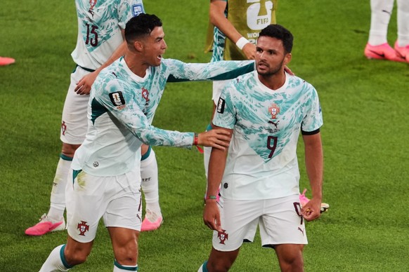Portugal's Goncalo Ramos (9) is congratulated by Cristiano Ronaldo after scoring a a goal during the World Cup round of 32 soccer match between Portugal and Croatia in Toronto, Thursday, July 2,  ...