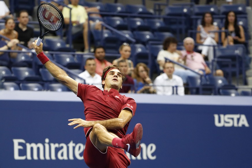 Roger Federer, of Switzerland, returns a shot to Yoshihito Nishioka, of Japan, during the first round of the U.S. Open tennis tournament, Tuesday, Aug. 28, 2018, in New York. (AP Photo/Adam Hunger)