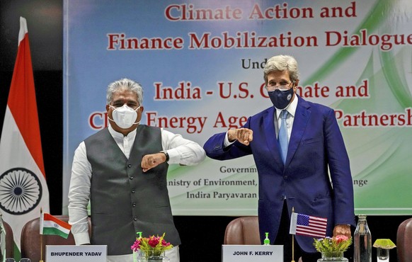 Indian Environment Minister Bhupender Yadav, left and U.S. Special Presidential Envoy for Climate John Kerry elbow bump during the launch of Climate Action and Finance Mobilisation Dialogue (CAFMD) un ...