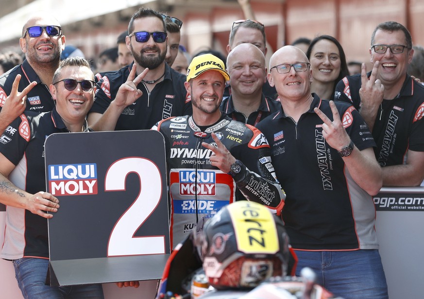 epa07650278 Swiss Moto2 rider Thomas Luthi (C) of the Kalex team celebrates after taking the second position in the qualifying session of the Motorcycling Grand Prix of Catalunya at the Circuit de Bar ...