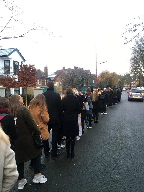 In this photo made available by Kelly Molloy, people queue to cast their ballots, at polling station, during the general election, in Clapham, London, Thursday, Dec. 12, 2019. Britain is holding an ea ...