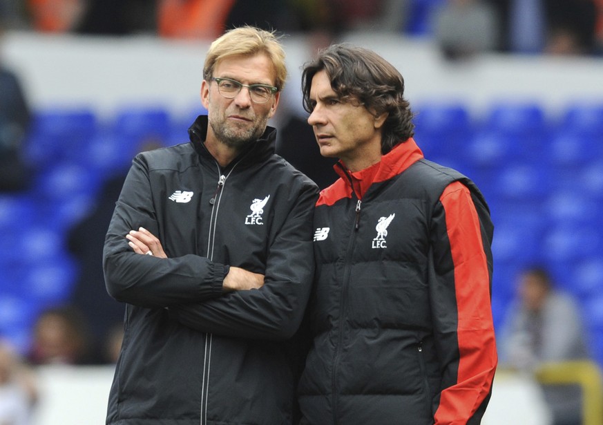 FILE - In this file photo dated Saturday, Oct. 17, 2015, Liverpool manager Juergen Klopp, left, talks with assistant manager Zeljko Buvac before their English Premier League soccer match against Totte ...