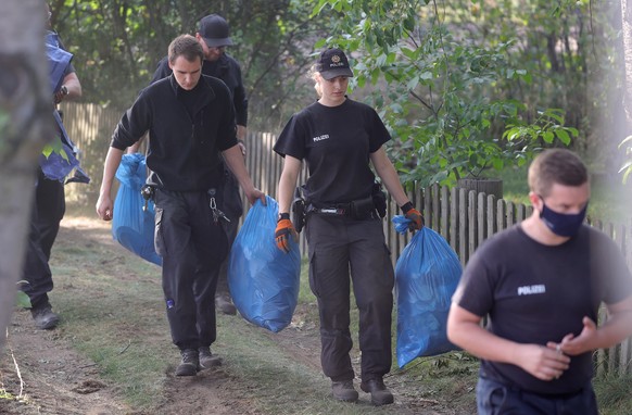 epa08573009 Police leave the operation site after search a garden plot in Hannover, northern Germany, 29 July 2020. Police is working on the site in relation to the investigation of the Madeleine &#03 ...