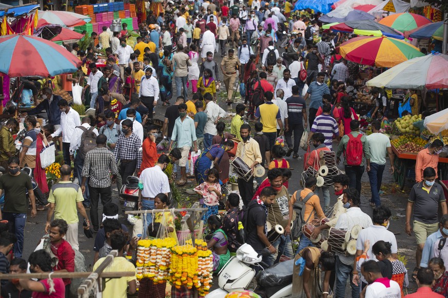 People crowd a market area on the first day of Ganesh Chaturthi festival in Mumbai, India, Friday, Sept. 10, 2021. The 10-day long Ganesh festival began Friday and ends with the immersion of Ganesha i ...