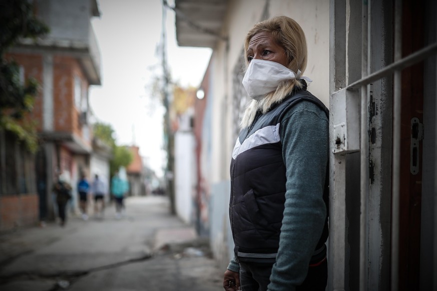 epa08415510 Mrs. Leonida Medina stands, at the door of her house, the place where her son was killed in Villa 21-24, in Buenos Aires, Argentina, 06 May 2020 (Issued 11 May 2020). Villa 21-24, located  ...