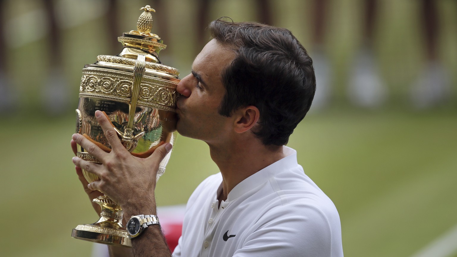 Switzerland&#039;s Roger Federer celebrates with the trophy after beating Croatia&#039;s Marin Cilic in the Men&#039;s Singles final match on day thirteen at the Wimbledon Tennis Championships in Lond ...