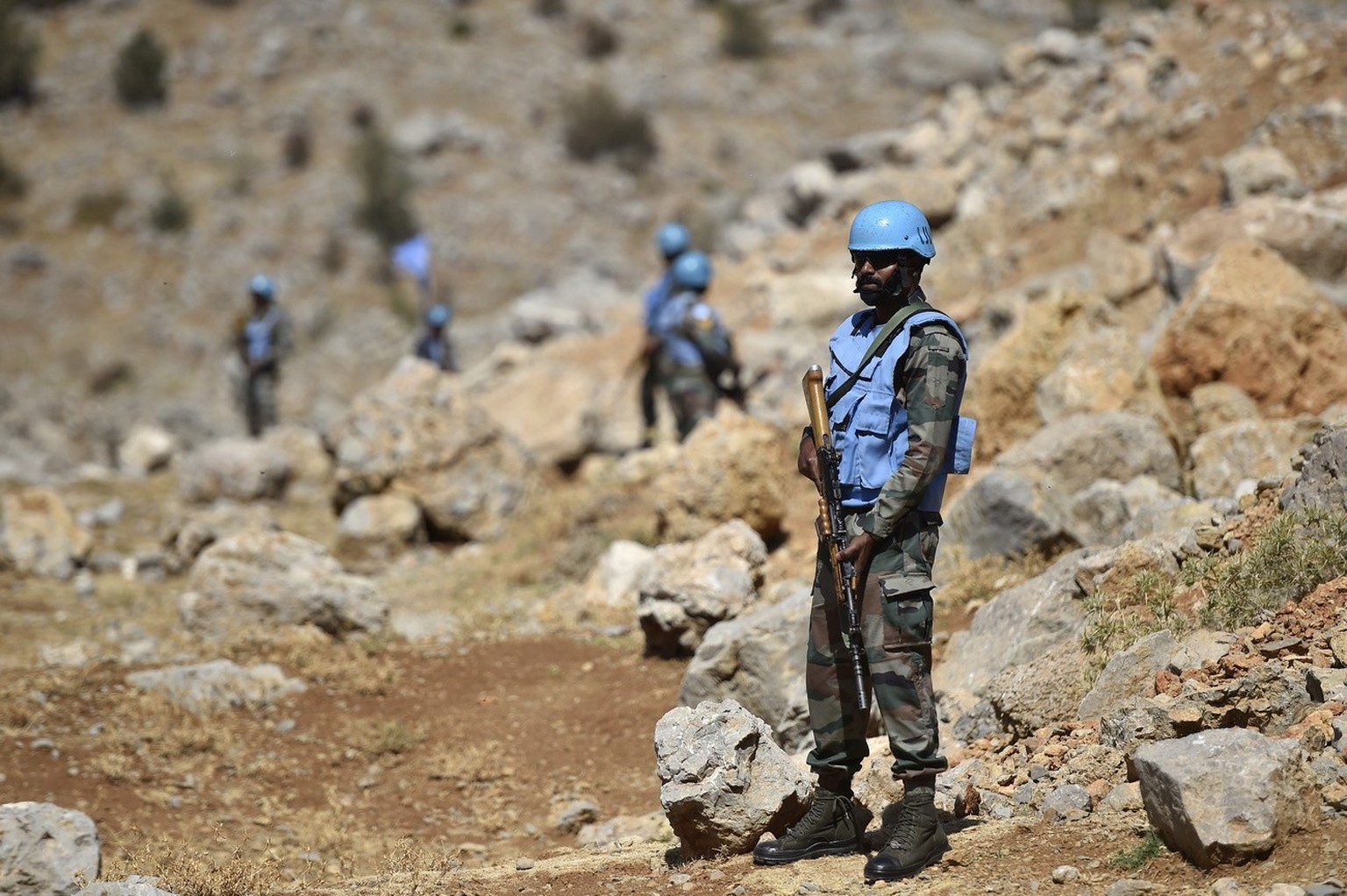 epa10161117 Soldiers of the UN peacekeeping mission, United Nations Interim Force In Lebanon (UNIFIL) keep watch at the Blue Line, the line of withdrawal between Lebanon and Israel, during a visit org ...