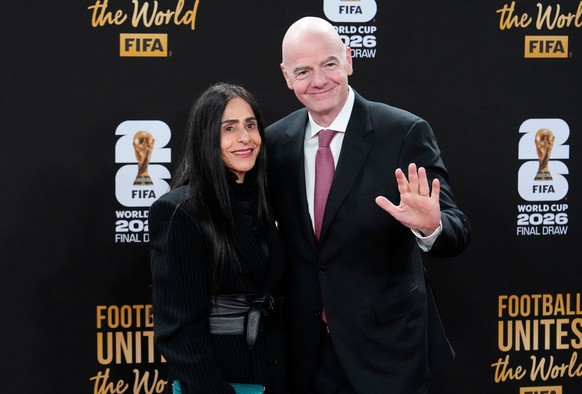 FIFA President Gianni Infantino and his wife Leena Al Ashqar pose for a photo as they arrive for a welcome reception ahead of the draw for 2026 soccer World Cup at the Kennedy Center in Washington, Th ...