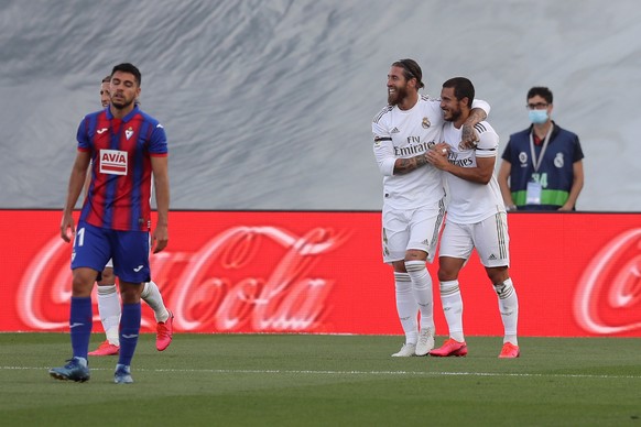 epa08485493 Real Madrid&#039;s Sergio Ramos (2-R) celebrates with teammate Eden Hazard after scoring the 2-0 lead during the Spanish LaLiga soccer match between Real Madrid and SD Eibar behind closed  ...