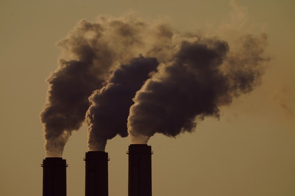 FILE - In this Saturday, Sept. 18, 2021 file photo, emissions rise from the smokestacks at the Jeffrey Energy Center coal power plant as the suns sets, near Emmett, Kansas, United States. The world ne ...