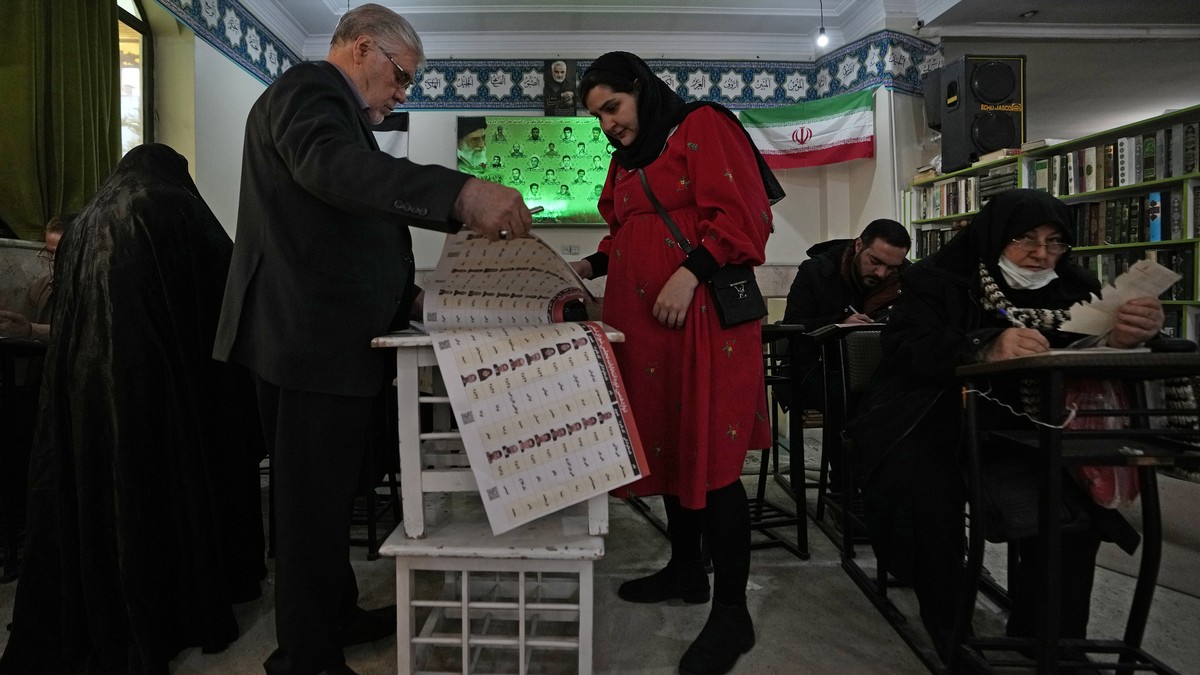 Voters fill out their ballots during the parliamentary and Assembly of Experts elections at a polling station in Tehran, Iran, Friday, March 1, 2024. Iran on Friday held the country's first elect ...