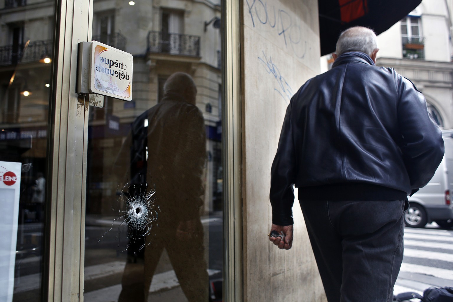 A bullet hole seen on the window of a cafe located near the area where the assailant of a knife attack was shot dead by police officers, in central Paris, Sunday May 13, 2018. The man behind a deadly  ...