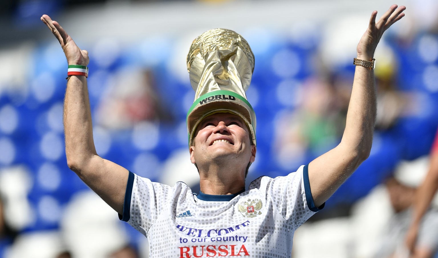 A fan with a hat depicting the World Cup trophy cheers prior to the group C match between Denmark and Australia at the 2018 soccer World Cup in the Samara Arena in Samara, Russia, Thursday, June 21, 2 ...