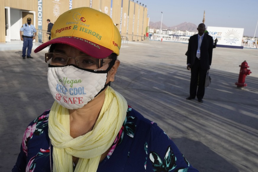 A face mask and hat promoting being vegan is worn at the COP27 U.N. Climate Summit, Monday, Nov. 14, 2022, in Sharm el-Sheikh, Egypt. (AP Photo/Peter Dejong)
