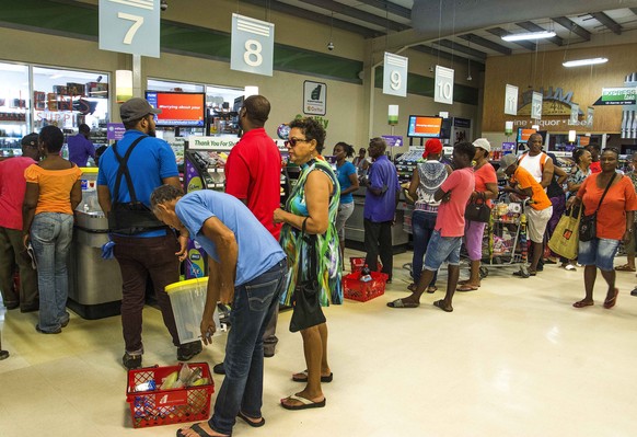 Residents stand in line at a grocery store as they prepare for the arrival of Tropical Storm Dorian, in Bridgetown, Barbados, Monday, Aug. 26, 2019. Much of the eastern Caribbean island of Barbados sh ...