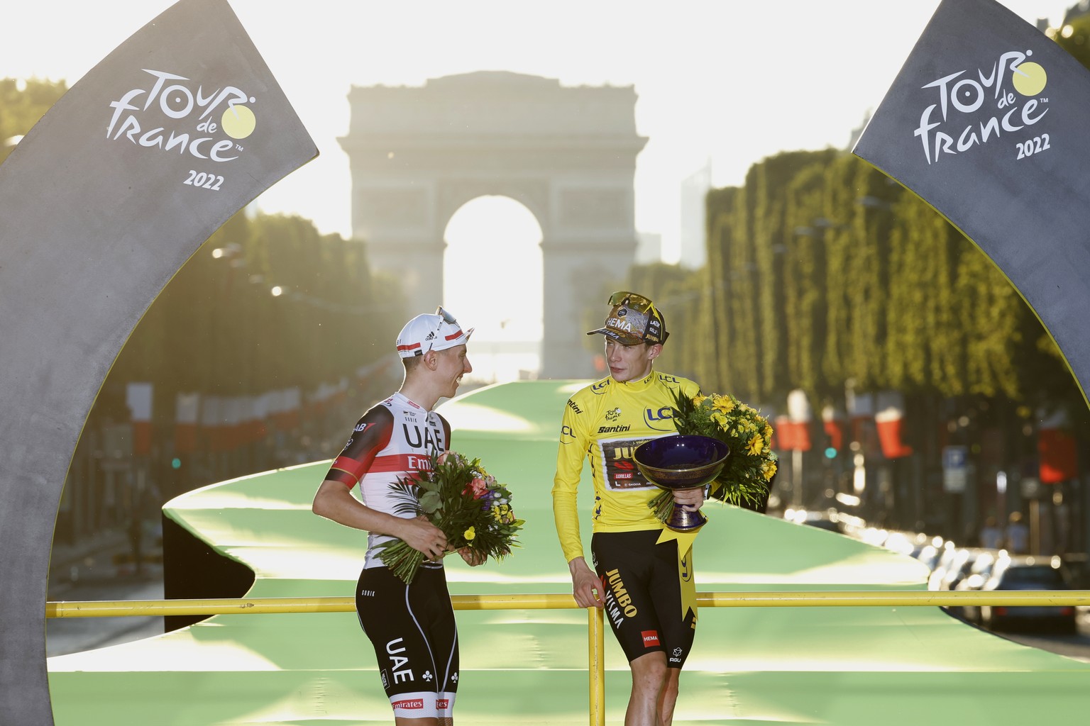 FILE - Tour de France winner Denmark&#039;s Jonas Vingegaard, wearing the overall leader&#039;s yellow jersey and Slovenia&#039;s Tadej Pogacar, wearing the best young rider&#039;s white jersey, leave ...