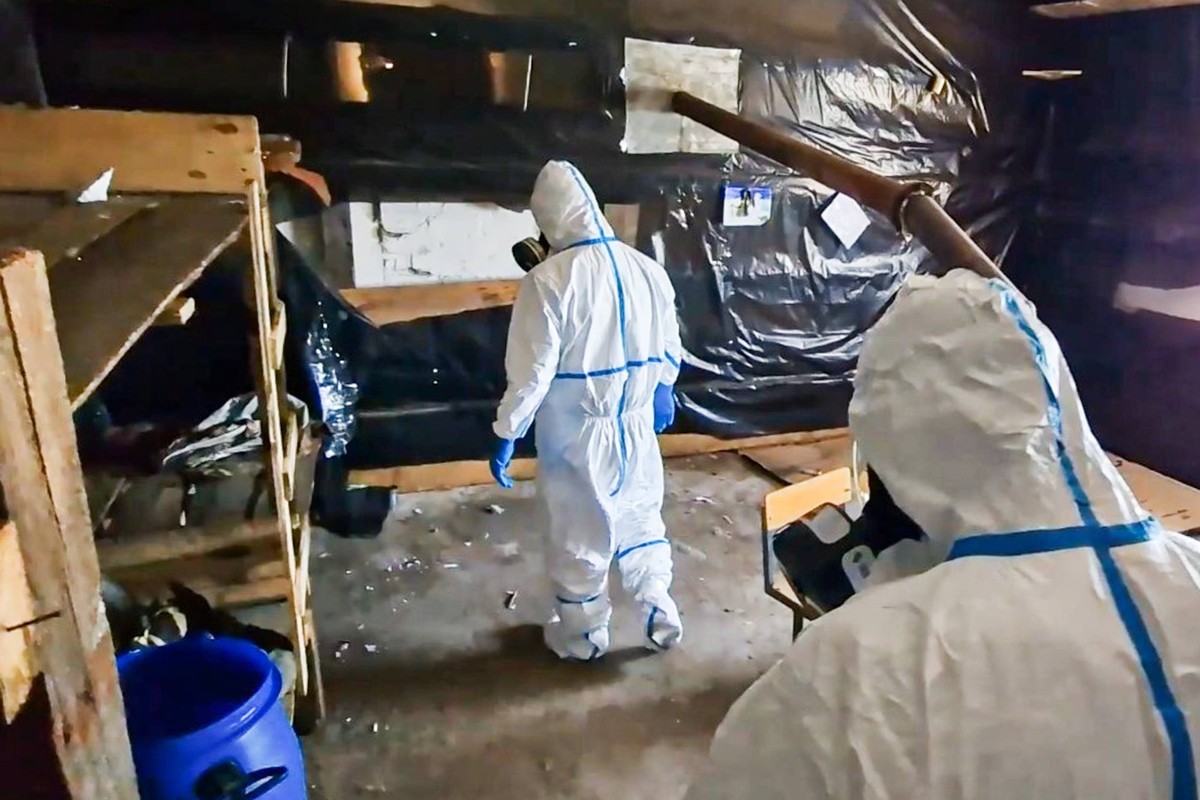 RUSSIA, DONETSK PEOPLE S REPUBLIC - JULY 1, 2025: Persons wearing protective suits discover a cache of improvised explosive devices containing chloropicrin, a chemical warfare agent prohibited under t ...