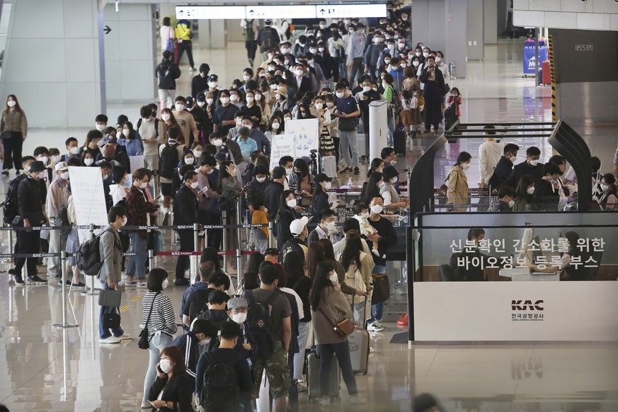 Passengers wearing face masks to help protect against the spread of the coronavirus line up to board planes ahead of the upcoming Chuseok holiday, the Korean version of Thanksgiving Day, at the domest ...