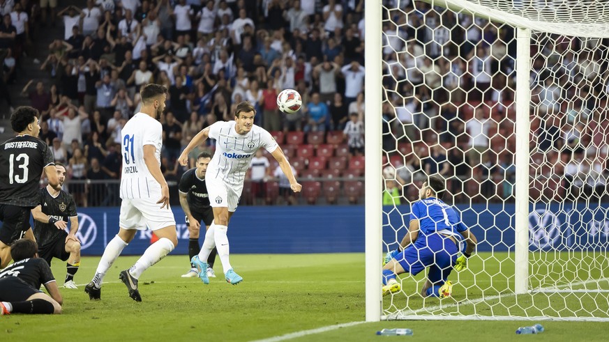 FC Zurich&#039;s Ivan Santini, center, heads to score a goal against Qarabag FK&#039;s Goalkeeper Shakhrudin Magomedaliyev, right, during the UEFA Champions League qualifying second round, second leg  ...