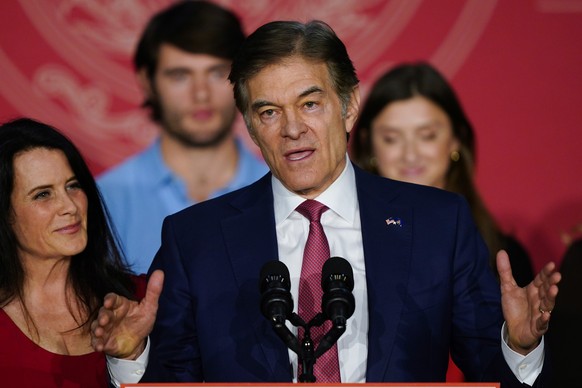 Mehmet Oz, the Republican candidate for U.S. Senate in Pennsylvania, speaks at an election night rally in Newtown, Pa., Tuesday, Nov. 8, 2022, as his wife Lisa listens at left. (AP Photo/Matt Rourke)