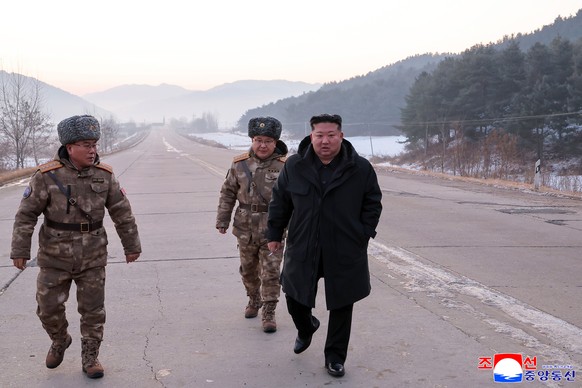 In this photo provided by the North Korean government, leader Kim Jong Un walks on a road as he inspects test-flights of hypersonic missiles, in Pyongyang, North Korea, Sunday, Jan. 4, 2026. Independe ...