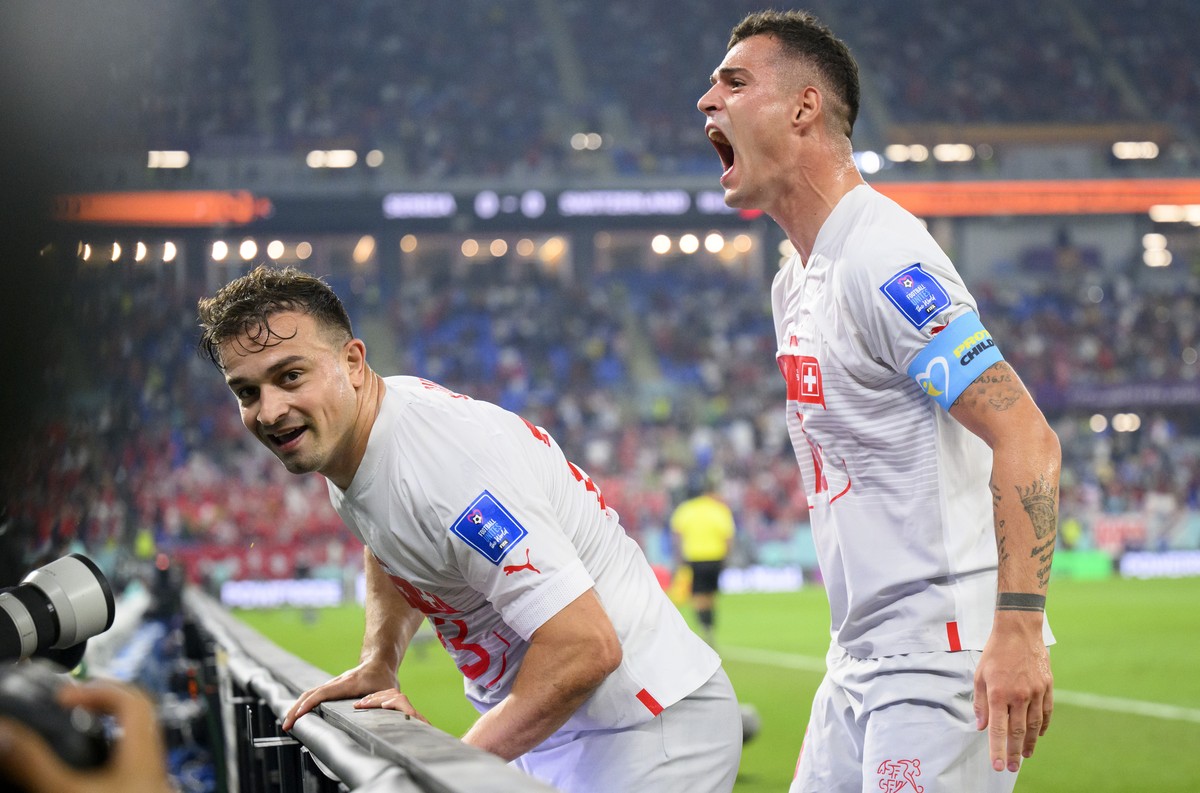 Switzerland's midfielder Xherdan Shaqiri, left, celebrates after scoring the first goal with Switzerland's midfielder Granit Xhaka, right, during the FIFA World Cup Qatar 2022 group G soccer ...
