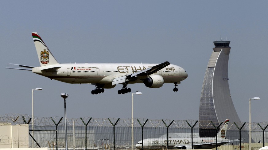 FILE - In this May 4, 2014 file photo, an Etihad Airways plane prepares to land at the Abu Dhabi airport in the United Arab Emirates. The capital of the United Arab Emirates became the first city to f ...