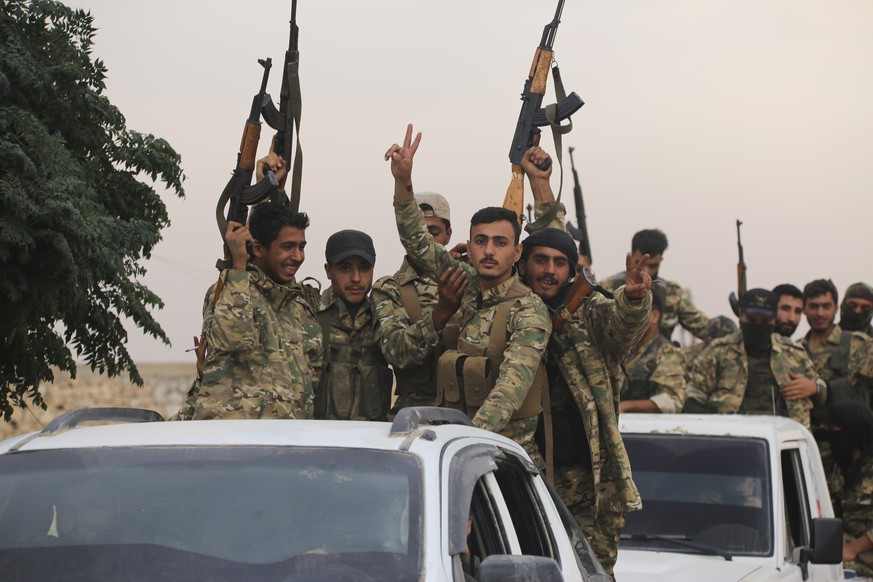 A convoy of Turkish backed Free Syria Army is about to cross into Turkey near the town of Azaz, Syria, Wednesday, Oct. 16, 2019. (AP Photo)