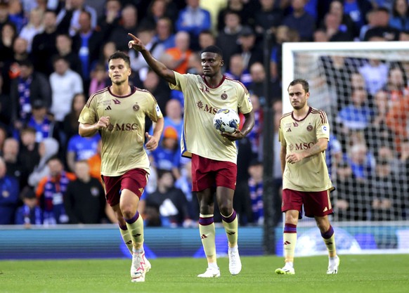 Servette FC&#039;s Chris Bedia, center, celebrates after scoring during the Champions League third qualifying round, first leg match between Rangers FC and Servette FC at the Ibrox Stadium, Glasgow, S ...