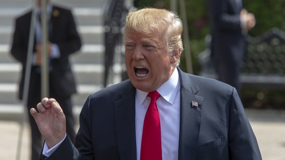 epa06954591 US President Donald J. Trump talks to the media before boarding Marine One on the South Lawn of the White House in Washington, DC, USA, 17 August 2018. Trump departs the White House for We ...