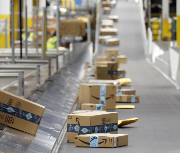 FILE - In this Dec. 17, 2019, file photo, Amazon packages move along a conveyor at an Amazon warehouse facility in Goodyear, Ariz. Amazon