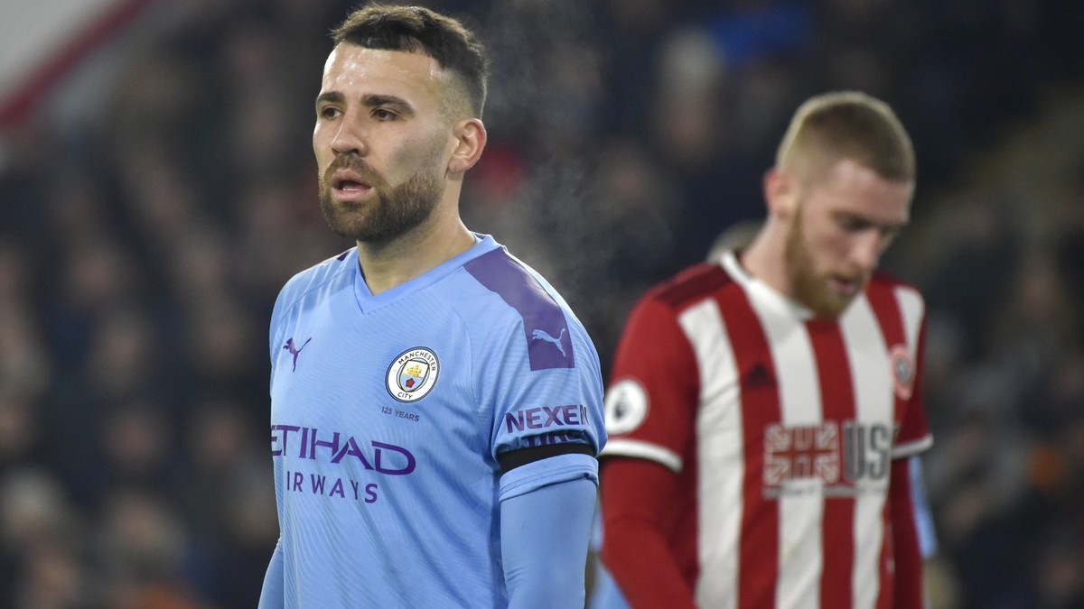 Manchester City's Nicolas Otamendi, left, during the English Premier League soccer match between Sheffield United and Manchester City at Bramall Lane in Sheffield, England, Tuesday, Jan. 21, 2020 ...