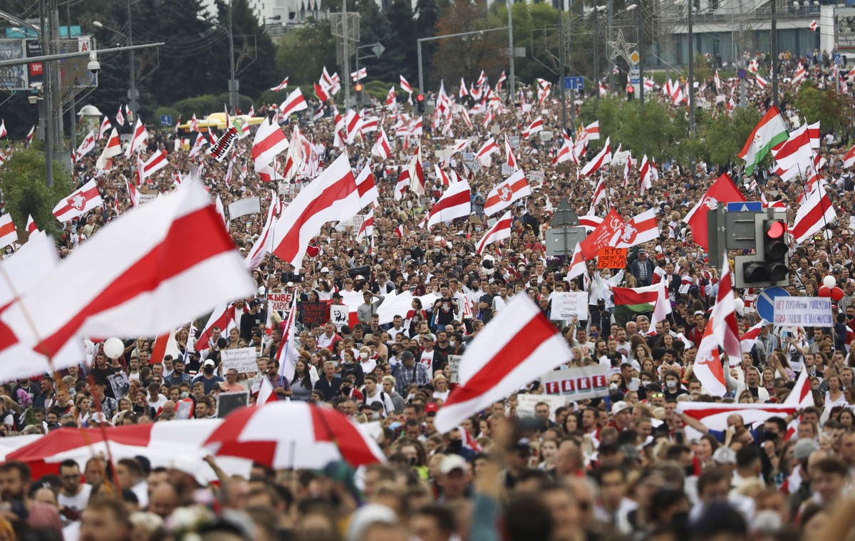 Protester carry old Belarusian national flags during an opposition rally to protest the official presidential election results in Minsk, Belarus, Sunday, Sept. 6, 2020. Sunday's demonstration mar ...