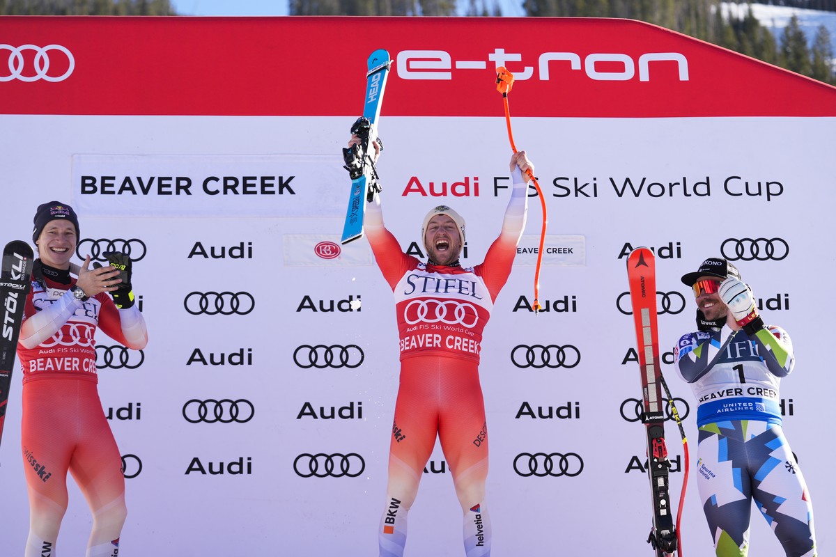 Switzerland's Justin Murisier, center, celebrates after winning a men's World Cup downhill skiing race, Friday, Dec. 6, 2024, in Beaver Creek. At left is Switzerland's Marco Odermatt, w ...