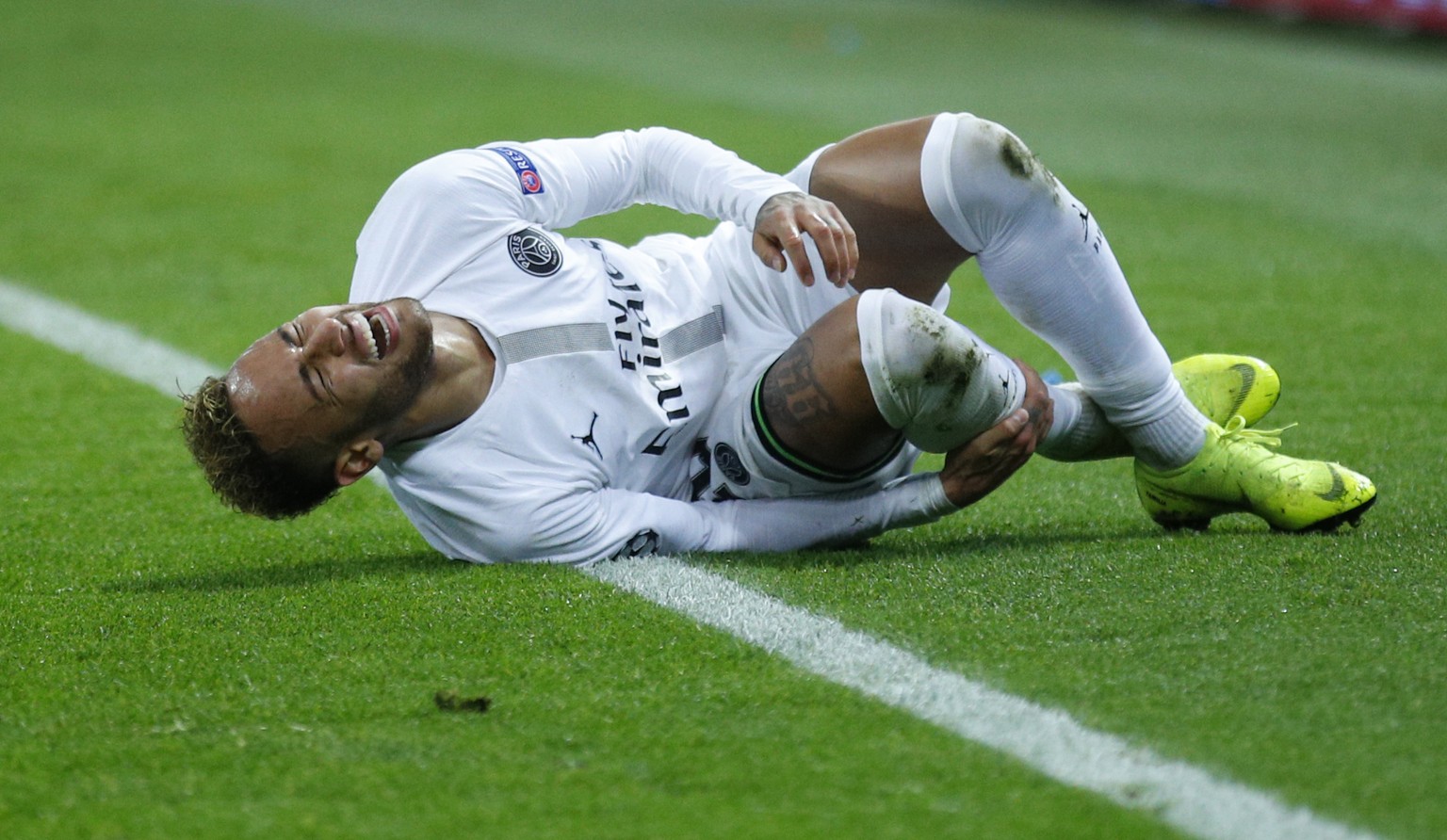 PSG forward Neymar screams after a tackle by Liverpool defender Andy Robertson during a Champions League Group C soccer match between Paris Saint Germain and Liverpool at the Parc des Princes stadium  ...