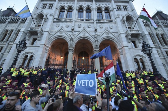 FILE - In this April 4, 2017 file photo demonstrators face policemen as they protest against the amendment of the higher education law seen by many as an action aiming at the closure of the Central Eu ...