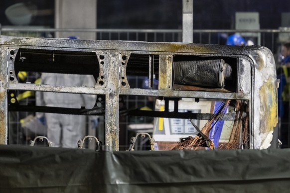 The rear of the charred shell of a postal bus pictured after catching fire in Kerzers, Switzerland, Tuesday, March 10, 2026. According to the Fribourg cantonal police, several passengers were killed a ...