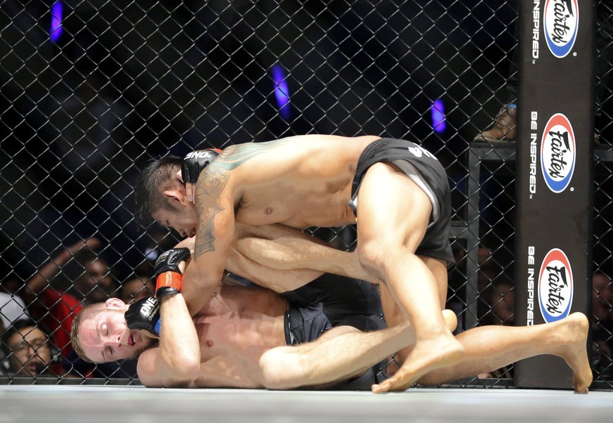 epa06058573 Aung La N Sang (up), also known as Burmese Python from Myanmar fights with Vitaly Bigdash (bottom) from Russia during their middleweight Mixed Martial Arts (MMA) ONE Championship bout at t ...