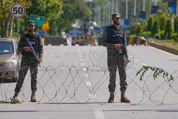 Soldiers stand guard at a checkpoint to ensure security ahead of the United States and Iran possible negotiations in Pakistani capital, in Islamabad, Pakistan, Friday, April 10, 2026. (AP Photo/Anjum  ...