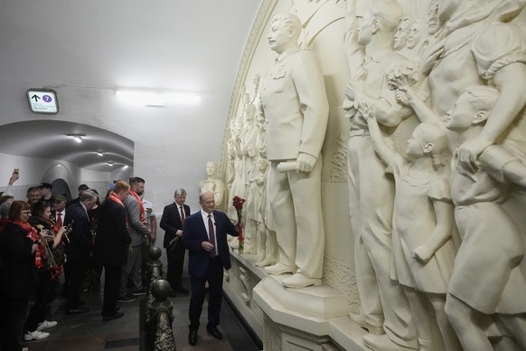 Russian Communist Party leader Gennady Zyuganov, right, lays flowers in front of a restored 1960 high relief &quot;The Gratitude of the People to Leader-Commander&quot; depicting Soviet leader Joseph  ...