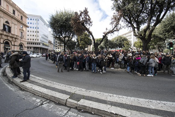 Students and teachers stand outside a highschool after it was evacuated following three earthquakes which hit central Italy in the space of an hour, shaking the same region that suffered a series of d ...