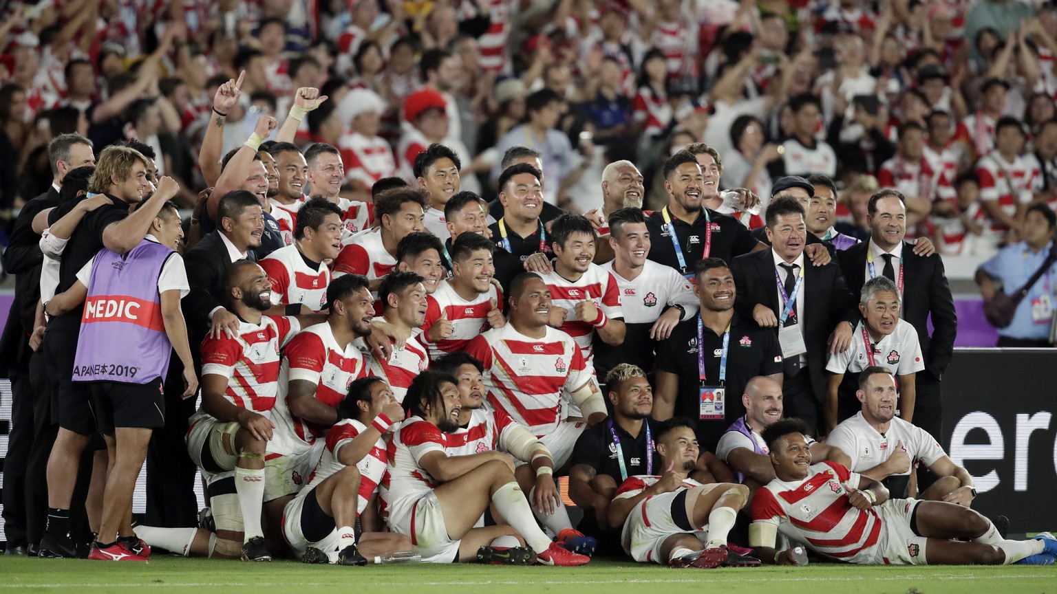 Players of the team Japan pose for photo after the Rugby World Cup Pool A game at International Stadium between Japan and Scotland in Yokohama, Japan, Sunday, Oct. 13, 2019. Japan won 28-21. (AP Photo ...