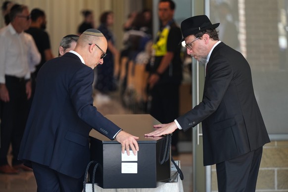 The coffin of Rabbi Yaakov Levitan, a victim in the Bondi Beach mass shooting, is carried into a chapel for his funeral in Sydney, Wednesday, Dec. 17, 2025. (AP Photo/Mark Baker)
Australia Shooting