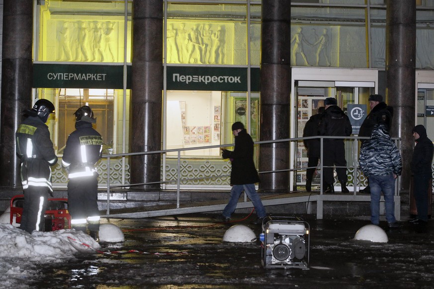 CAPTION CORRECTS THE DATE - Police stand at the entrance of a supermarket, after an explosion in St.Petersburg, Russia, Wednesday, Dec. 27, 2017. Russian officials say at least 10 people have been inj ...